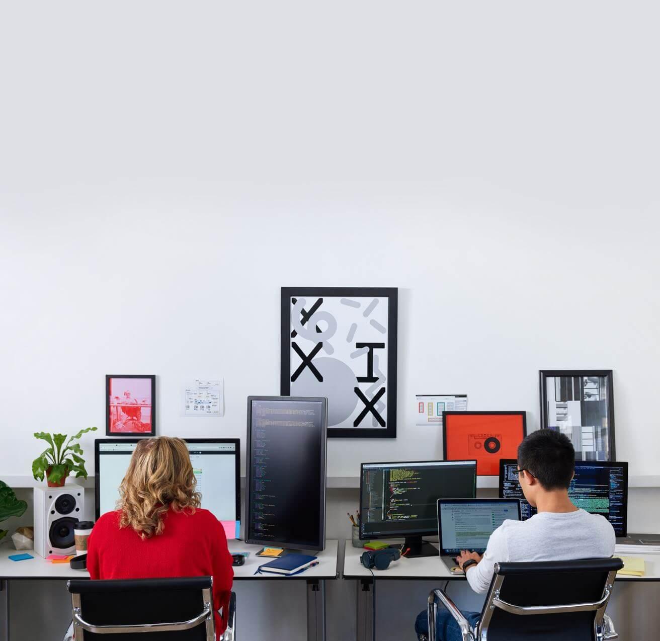 Man and woman working at their computers.